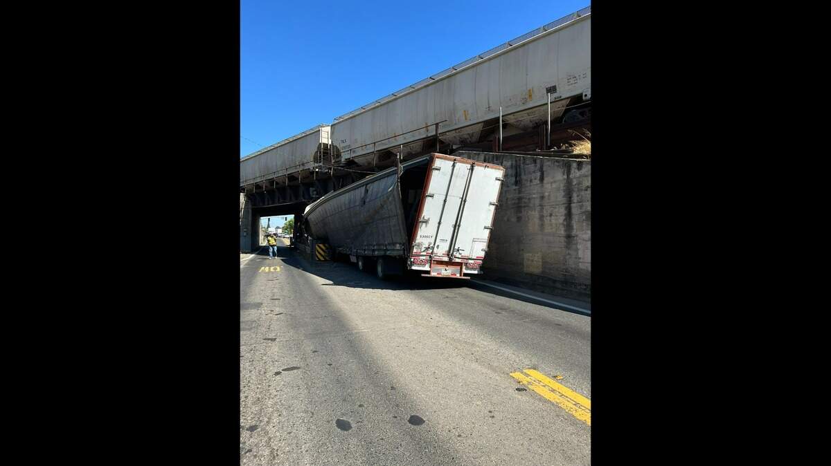 A semitruck rests collided into a train overpass Wednesday, Highway 70 at 18th Street in Marsyville. The crash shut down the roadway in both directions.