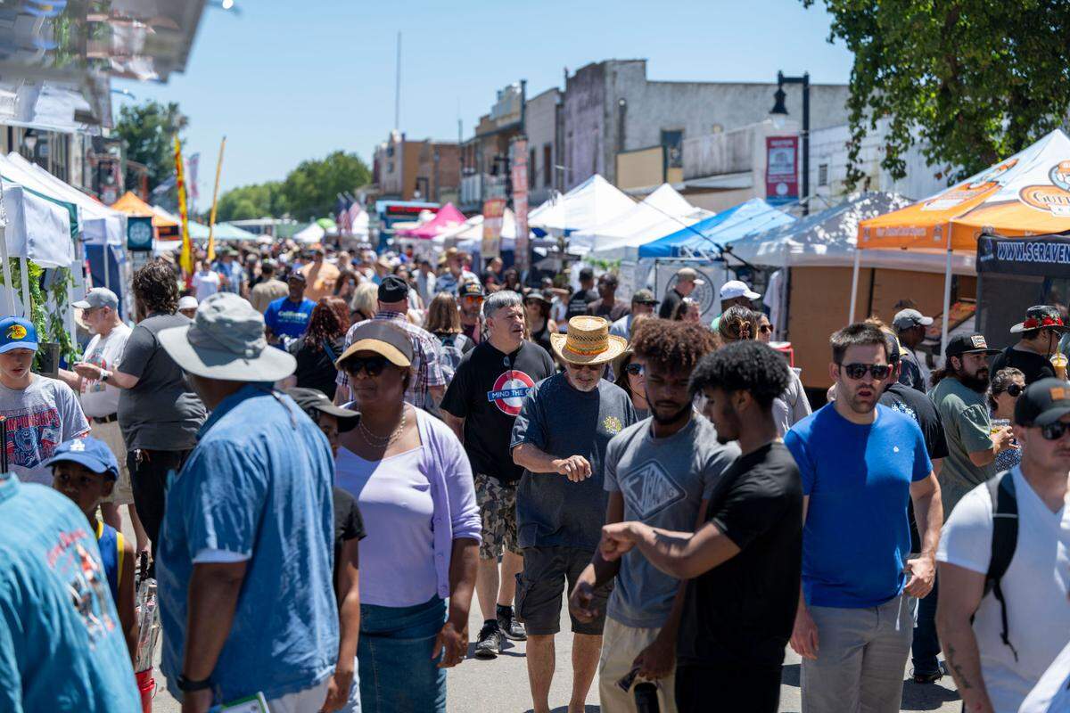 People walk through the craft and food vendors at the City of Isleton Crawdad Festival on Sunday.