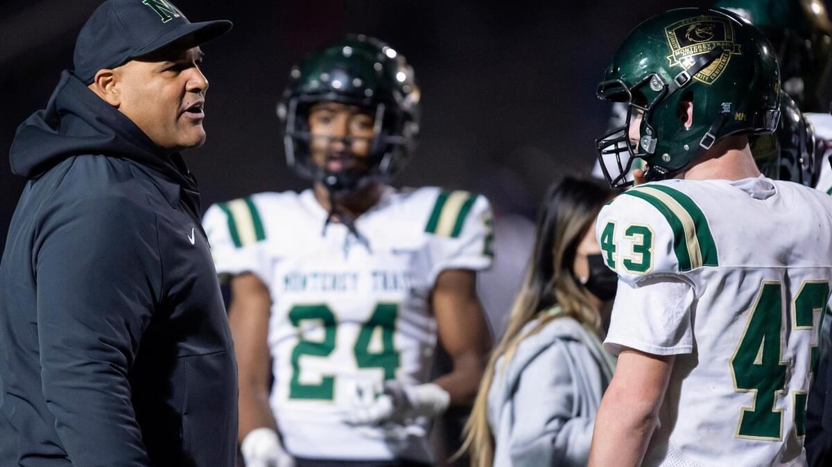 Monterey Trail Mustangs head coach T.J. Ewing talks with the team during a timeout during the third quarter of the Sac-Joaquin Section Division II semifinals playoff game at Elk Grove High School in Elk Grove on Friday, Nov. 12, 2021. The Mustangs won 27-23.