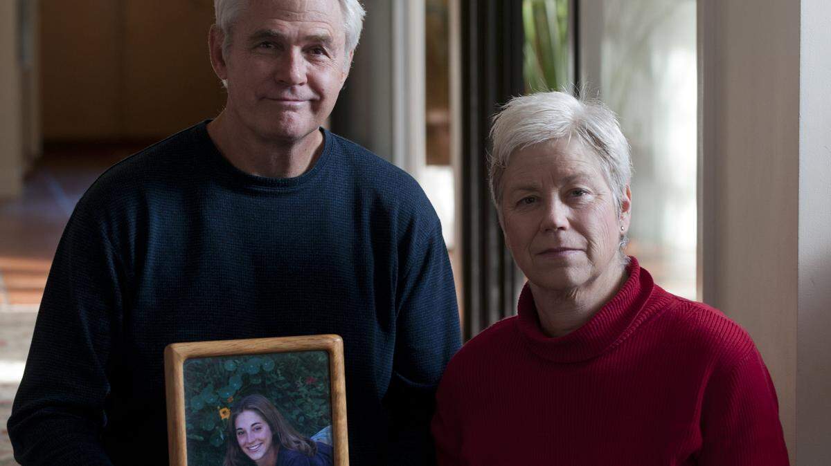 Nick and Amanda Wilcox hold a photo of their daughter Laura at their Penn Valley home in 2011. Laura Wilcox was killed in 2001 by a mentally ill man who went on a shooting rampage at her Nevada County workplace. Laura’s Law is named after her.