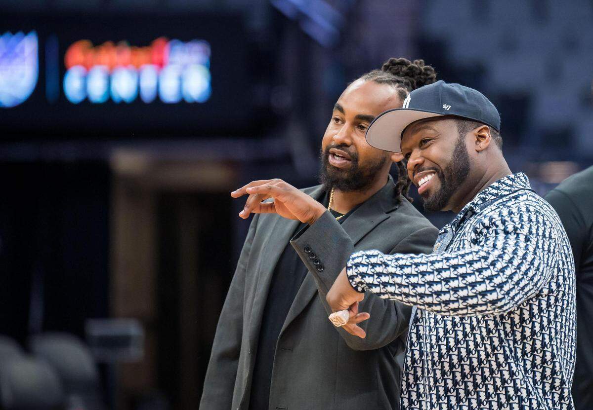 Kings and Queens Rise Co-Ed Youth Sports and Mentoring League Commissioner Kenneth Duncan, left, speaks with entertainer and businessman Curtis “50 Cent” Jackson during a Sacramento Kings event presented by the G-Unity Foundation at Golden 1 Center on Saturday, June 10, 2023, to kick off the league’s sixth season in Sacramento.