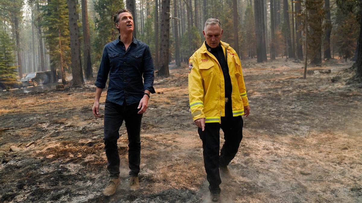 California Gov. Gavin Newsom, left, and Cal Fire Chief Thom Porter tour the area scorched by the Caldor Fire in Eldorado National Forest, Calif., Wednesday, Sept. 1, 2021.