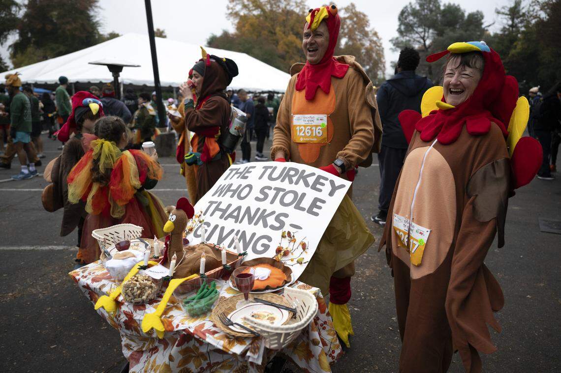 Tressa Tabares and Robert Tabares show off their Thanksgiving Day table spread costume before the starts of the Run to Feed the Hungry in Sacramento on Thursday. The Tabareses have been running the race for years, adding new items to their table each time.