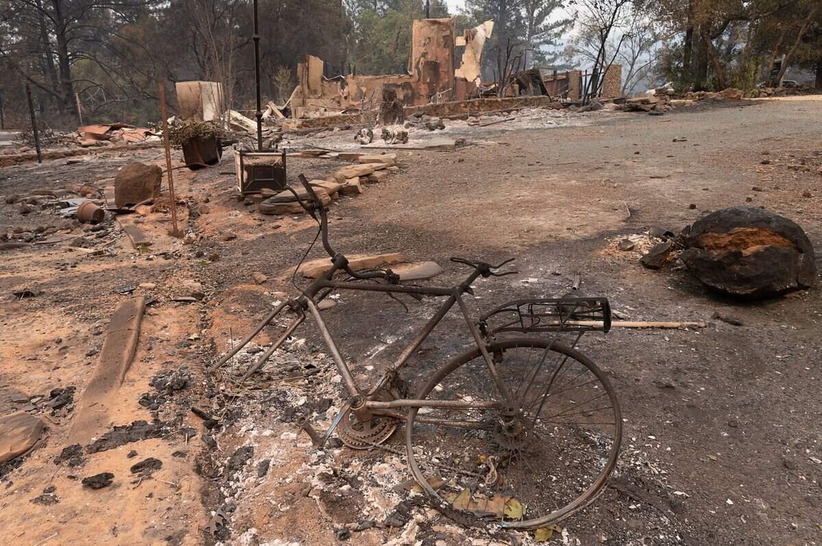 The remains of a bicycle lay on the ground near a burned building on Mund Road in Deer Park on Monday, Sept. 28, 2020 after the Glass Fire burned in Napa County.