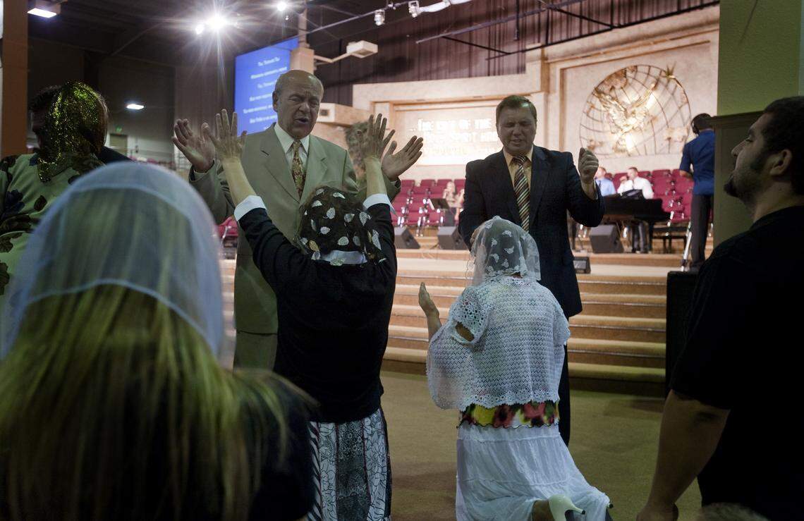 In a 2010 file photo, pastors help to channel prayers from members of the congregation at Bethany Slavic Missionary Church during Sunday morning services.