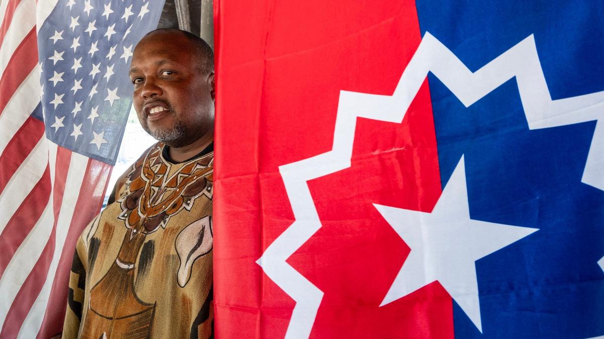 Michael Harris stands between the American and the Juneteenth flags in Folsom on Friday. Harris is part of a statewide movement, National Juneteenth Observance Foundation-California, to urge California cities to observe Juneteenth as an official public holiday.