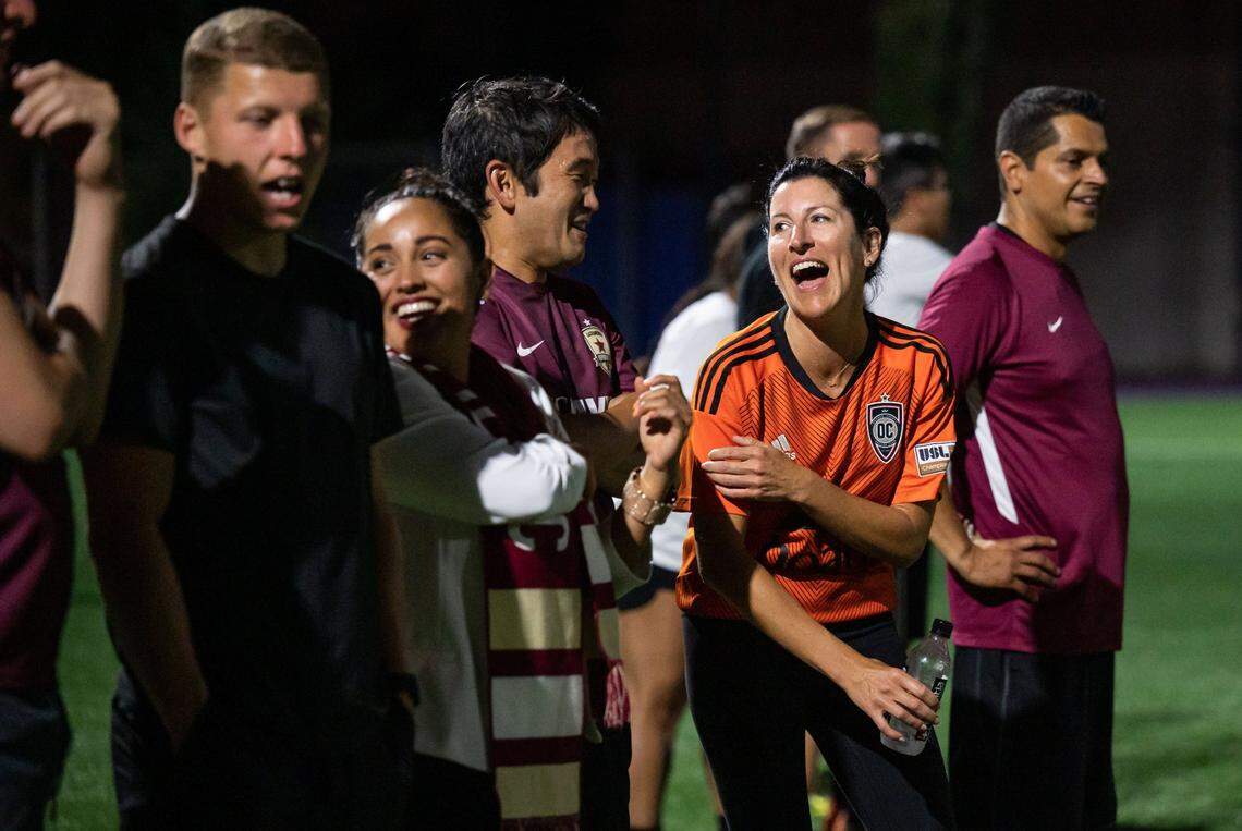 Assemblywoman Cottie Petrie-Norris, D-Laguna Beach, jokes with Southern California teammate state Sen. Dave Min, D-Irvine, on the sidelines during the second half of the annual Capitol Cup charity soccer game Wednesday at Cristo Rey High School in Sacramento.