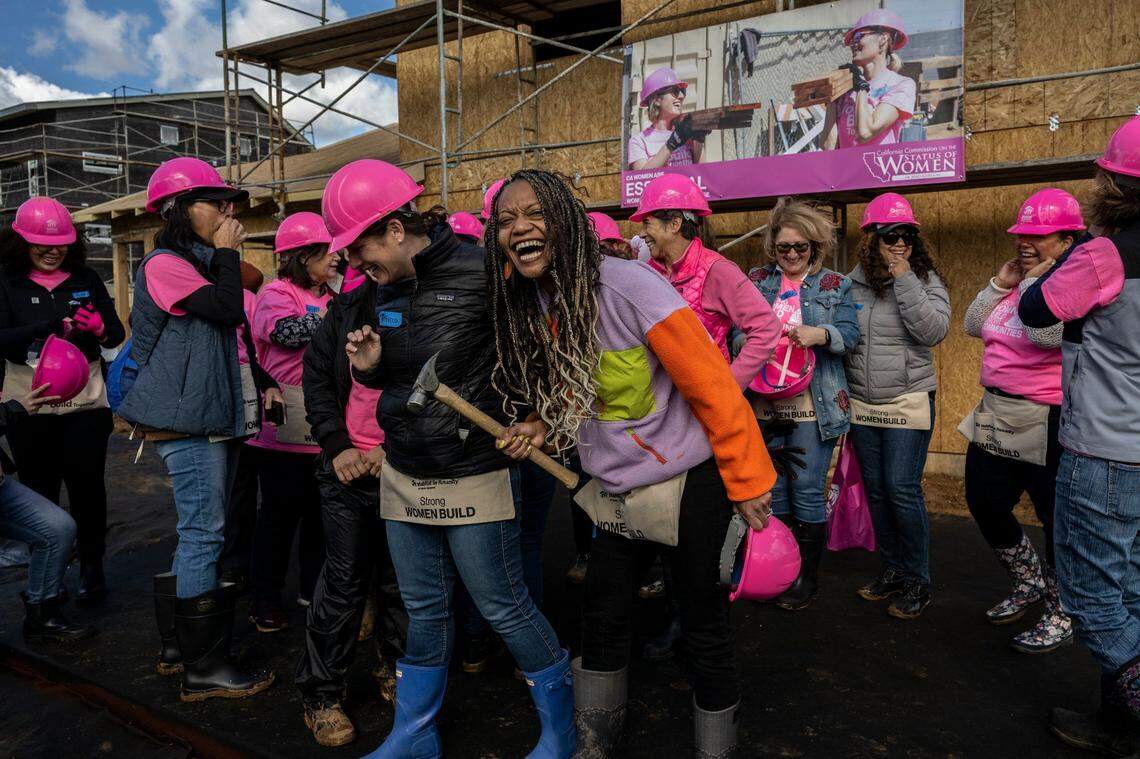 Lauren Babb, chair of the California Commission on the Status of Women and Girls, carries a hammer as she gets ready to lead a group of women volunteers at a Habitat for Humanity event to celebrate International Women’s Day in Sacramento on Wednesday.