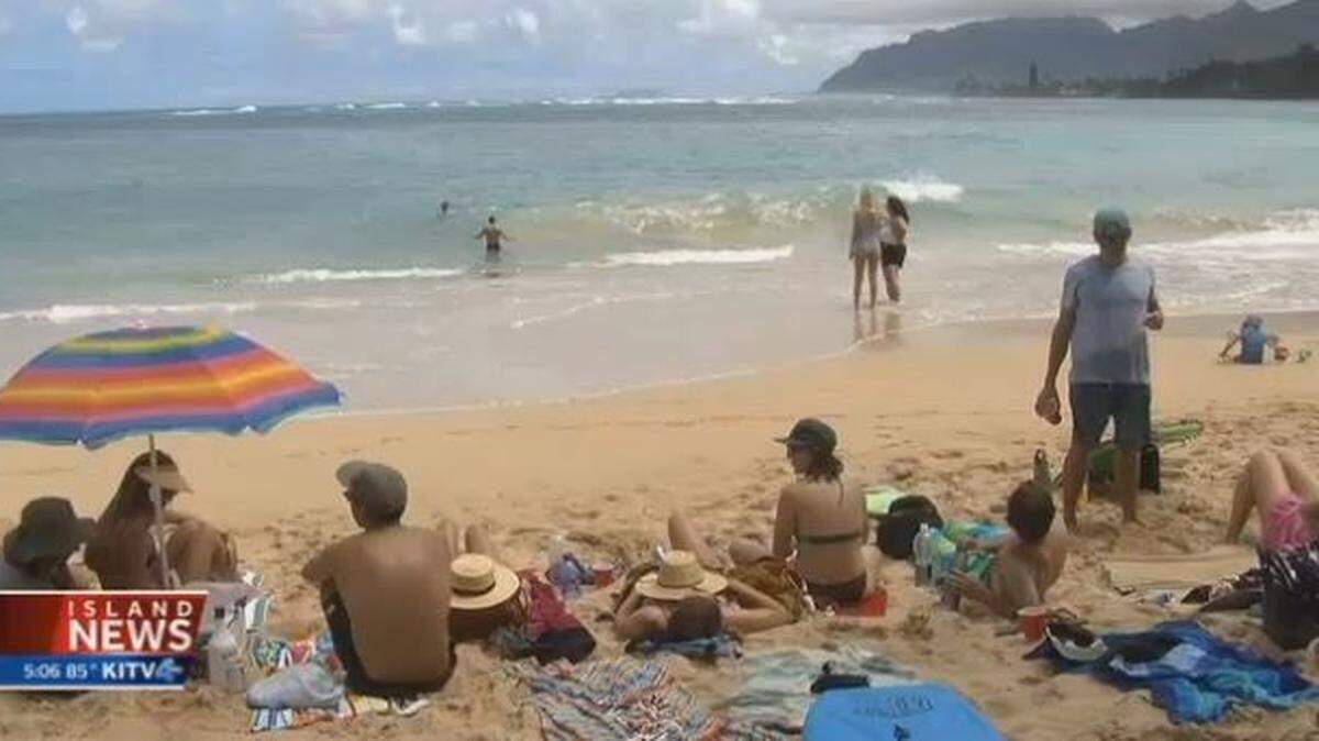 Fellow surfers carried a 23-year-old man to safety on their surfboards after he was attacked Saturday morning by a shark off Pounders Beach on Oahu. The man underwent surgery for an arm wound.