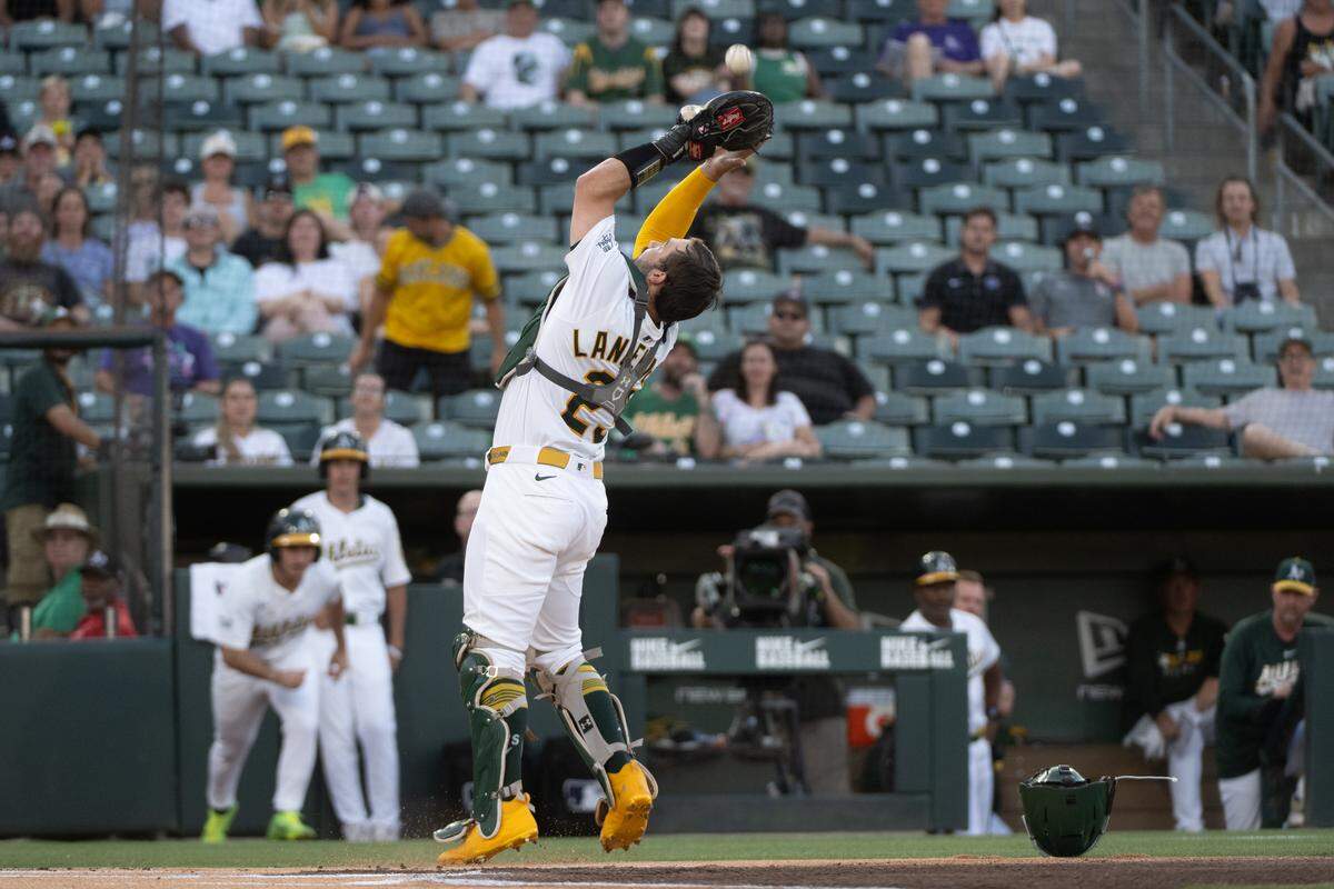 Tampa Bay Rays shortstop Ha-Seong Kim (7) pops up to Athletics catcher Shea Langeliers (23) in the first inning during a game at Sutter Health Park on Aug. 11. Empty seats could be seen as the game had a paid attendance of 7,731, the lowest of the season.