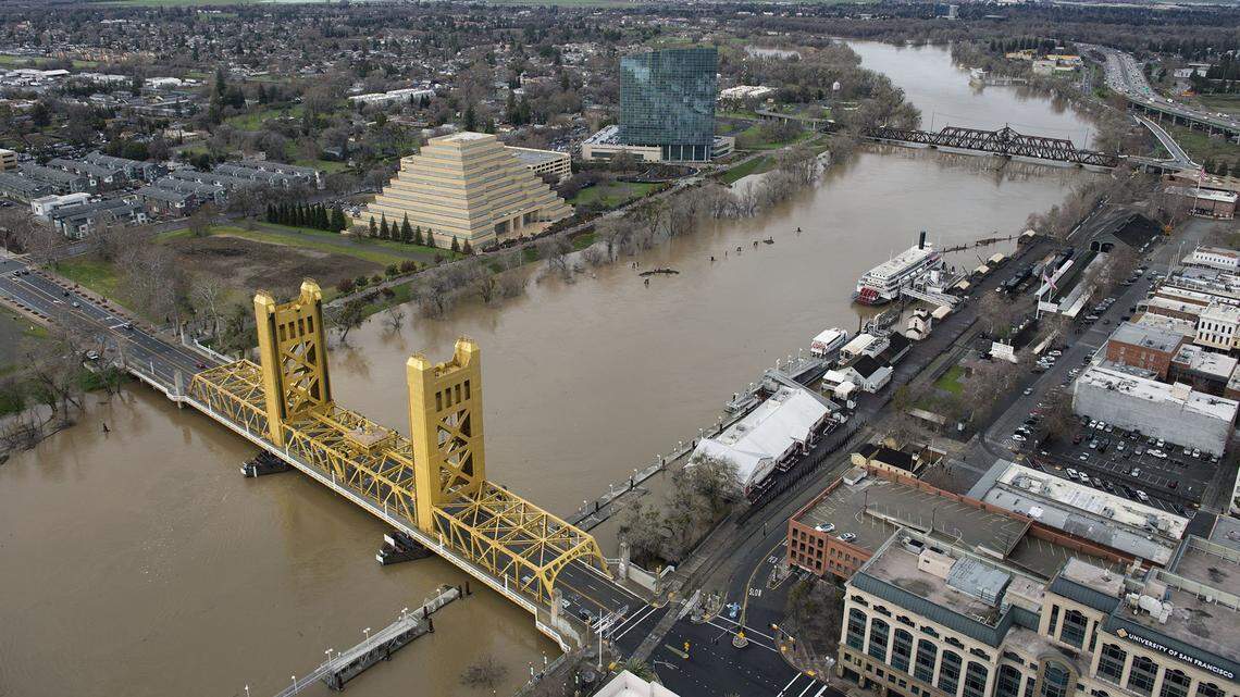 Muddy water from the Sacramento River flows underneath the Tower Bridge that connects Sacramento and West Sacramento. A Sacramento Police Department captain tweeted the bridge was closed, but a spokesman said it Capitol Mall east of the bridge that was closed.