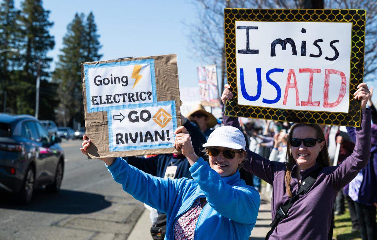 Demonstrators rally against Elon Musk at a Tesla dealership on Arden Way near Sacramento on Saturday, March 8, 2025. More than 100 people lined both sides of street to protest the role of the tech billionaire and Tesla CEO in the Trump administration.