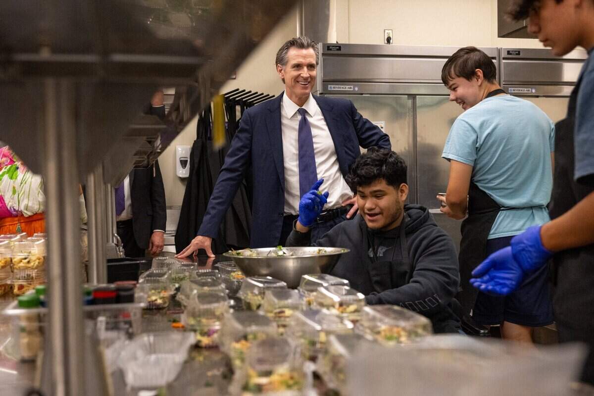 Gov. Gavin Newsom smiles with students in the Career Technical Education Pathways program at River City High School in West Sacramento on Thursday.
