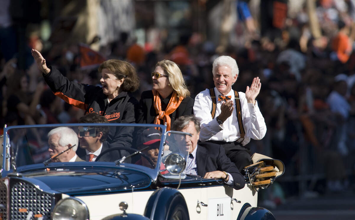 Sen. Diane Feinstein, left, and Giants owner Bill Neukom ride in a vintage car as the the San Francisco Giants celebrate their World Series win with a parade down Market Street in San Francisco on Nov. 3, 2010.