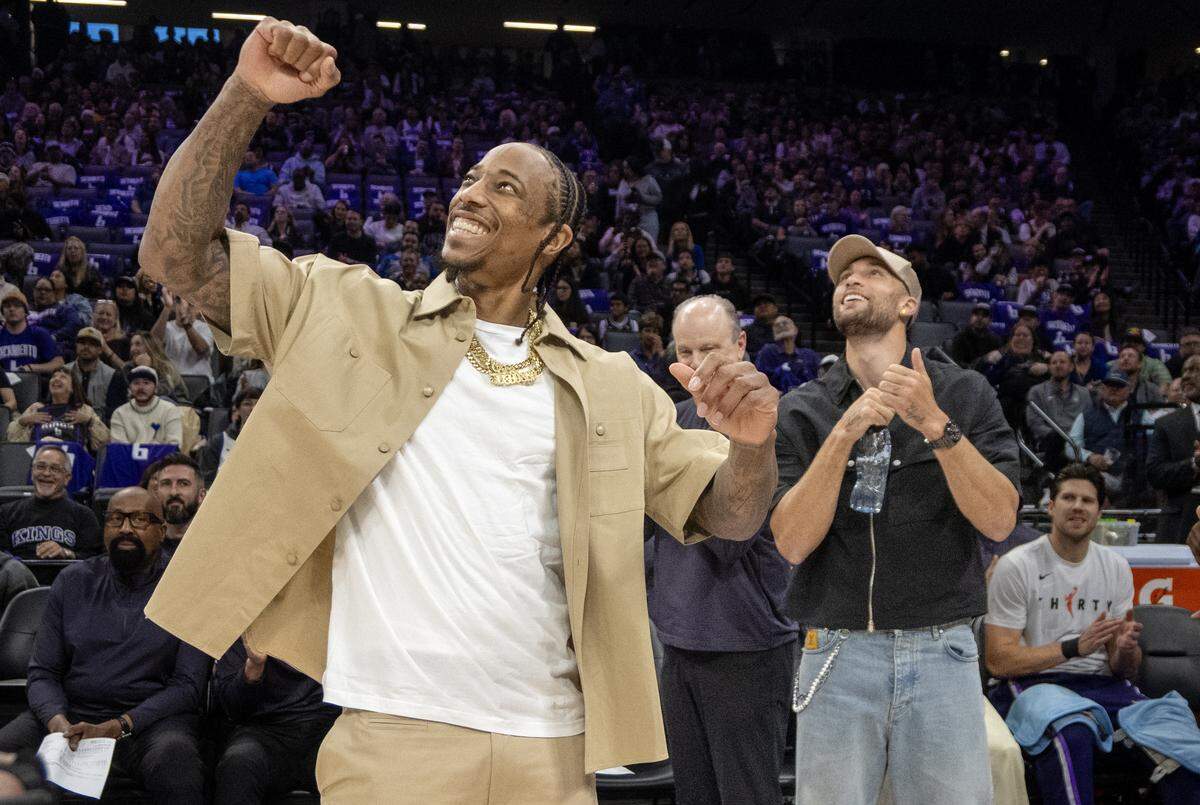 Sacramento Kings guard DeMar DeRozan (10) reacts after watching a video presentation of his career in the first half in the game against the Golden State Warriors on Friday at Golden 1 Center.