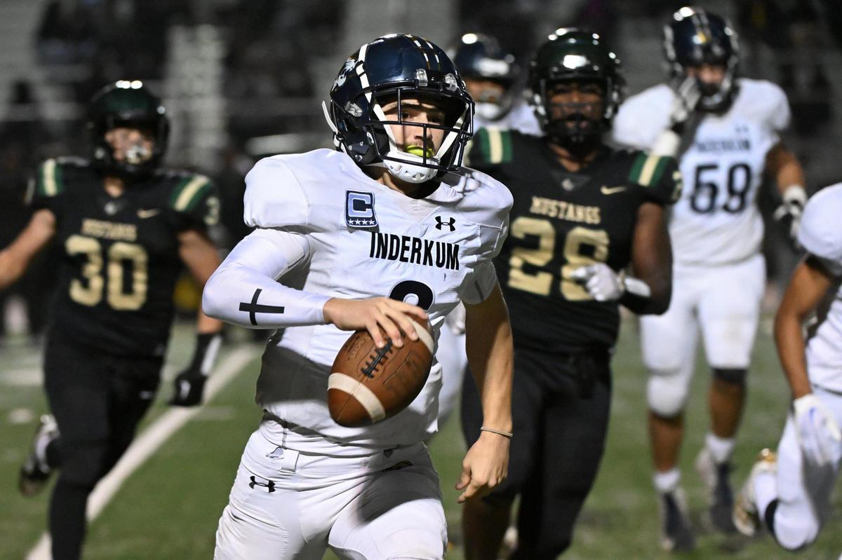 Inderkum Tigers quarterback Ricky Cole (6) runs the ball before being pushed out of bounds by Monterey Trail Mustangs linebacker Donte Jacobs (26) in a CIF Sac-Joaquin Section Division I quarterfinal game on Nov. 10, 2023, at Monterey Trail High School in Elk Grove.