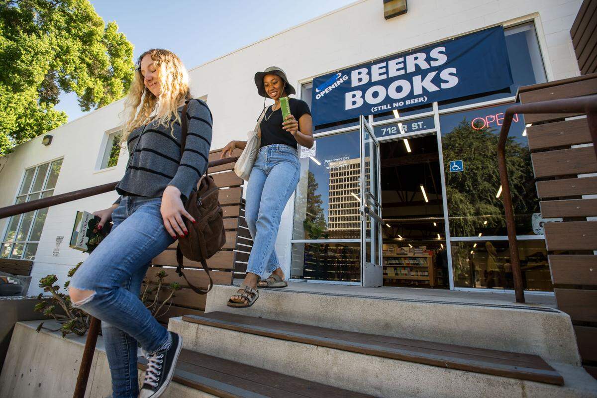 Frances Nelson, left, and English Price, both of Sacramento, leave Beers Books with their purchases during the longtime business’ soft opening at their new location at 712 R St. on Saturday, Aug. 26, 2023, in Sacramento.