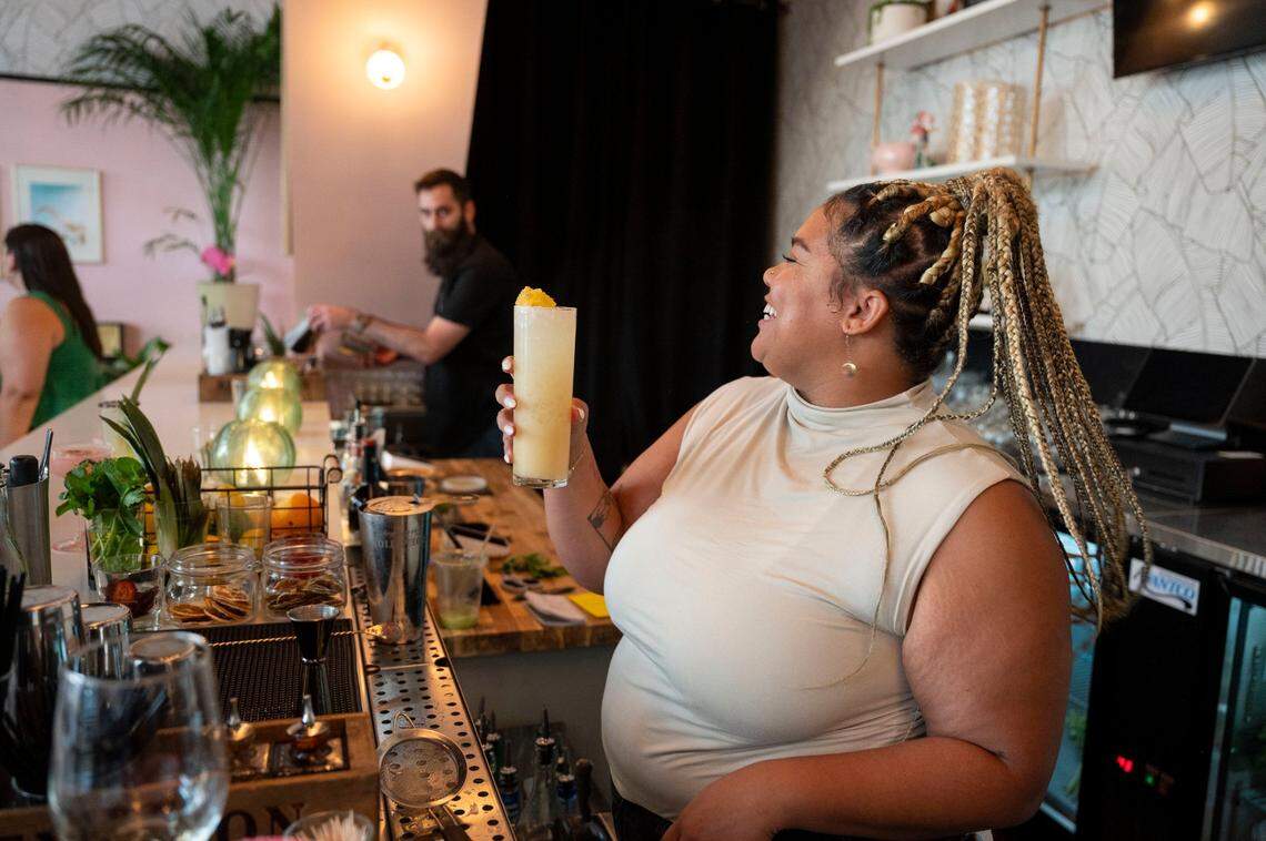 Cabana Club bartender Kayla Johnson mixes a drink at the new Palm Springs-inspired cocktail lounge and eatery in Downtown Commons during a sneak peek event Wednesday.