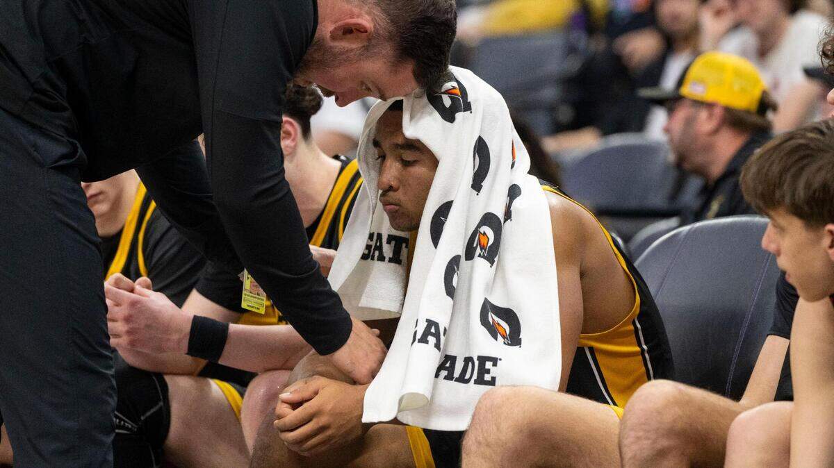 Del Oro High School guard Caden Pinnick is encouraged by coach Luke Vaughn after losing to Vanden during the CIF Sac-Joaquin Section Division II boys basketball championship game on Wednesday at Golden 1 Center.