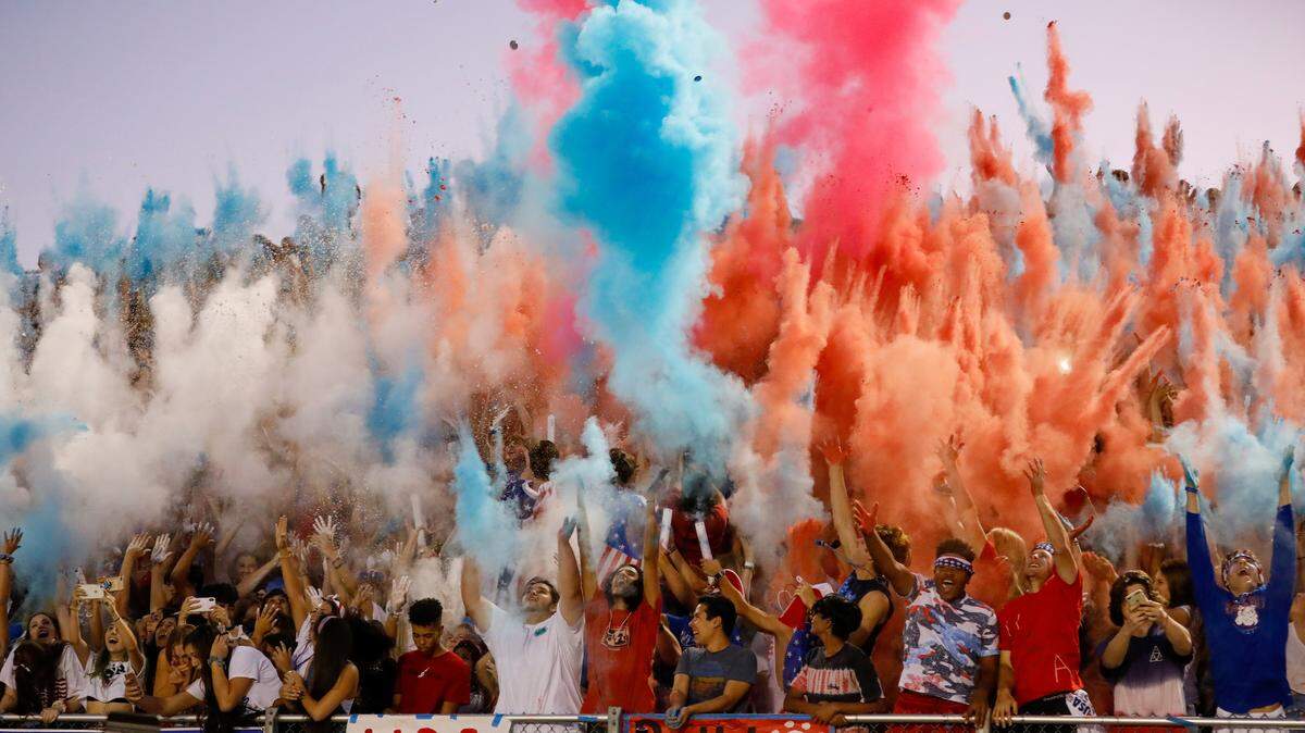 Folsom football fans launch colored powder into the air at a game. It’s one of the more raucous student sections in the Sacramento area.