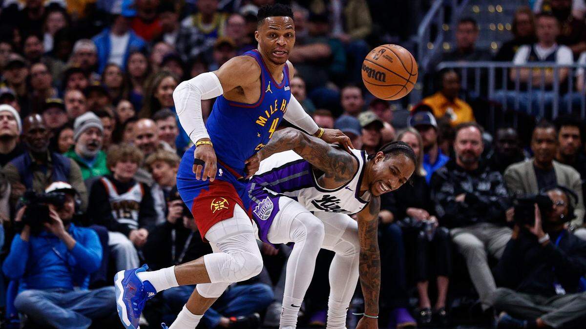 Mar 5, 2025; Denver, Colorado, USA; Denver Nuggets guard Russell Westbrook (4) strips the ball away from Sacramento Kings forward DeMar DeRozan (10) in the second quarter at Ball Arena. Mandatory Credit: Isaiah J. Downing-Imagn Images