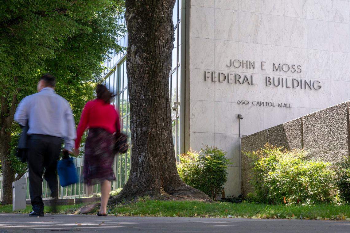 People walk by the John Moss federal building in downtown Sacramento in June.