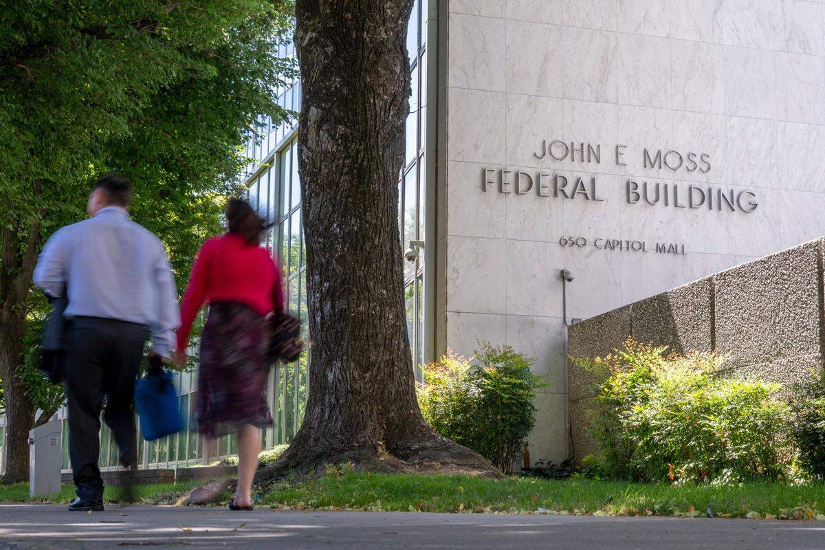 People walk by the John E. Moss federal building in downtown Sacramento on Wednesday.