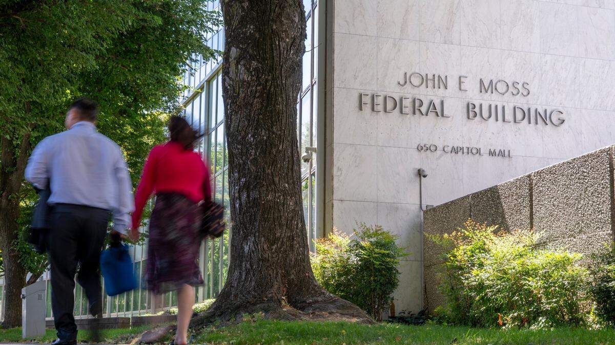 People walk by the John E. Moss federal building in downtown Sacramento on Wednesday, June 11 2025.