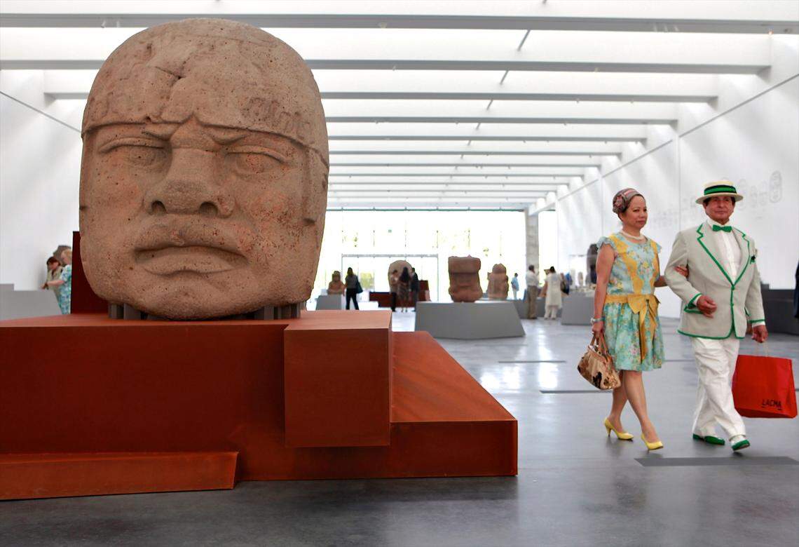 Visitors explore the inaugural exhibit in 2010 of the Lynda and Stewart Resnick Exhibition Pavilion, the product of a $45 million donation by the family, at the Los Angeles County Museum of Art, featuring a colossal Olmec head from ancient Mexico. The family’s philanthropy includes education and the arts.