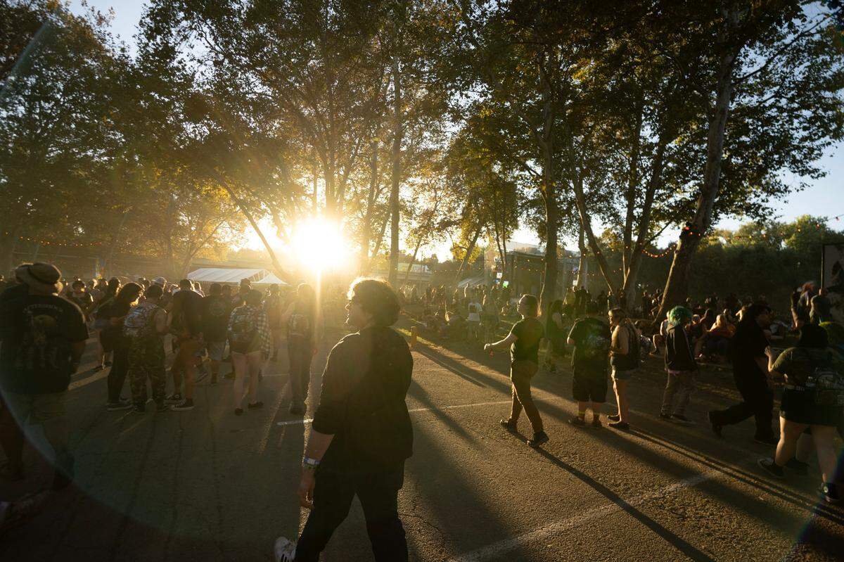 Festival attendees make their way to different venues in the first day of the Aftershock festival on Thursday at Discovery Park.