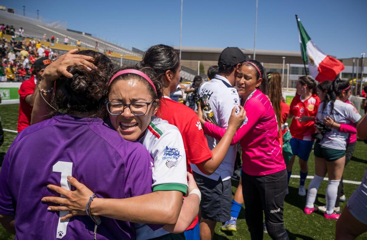Mexico women’s player Ana Karen Dominguez, embraces the Chile goalkeeper after Mexico’s win in the championship at the Homeless World Cup on Saturday at Sacramento State’s Hornet Stadium.