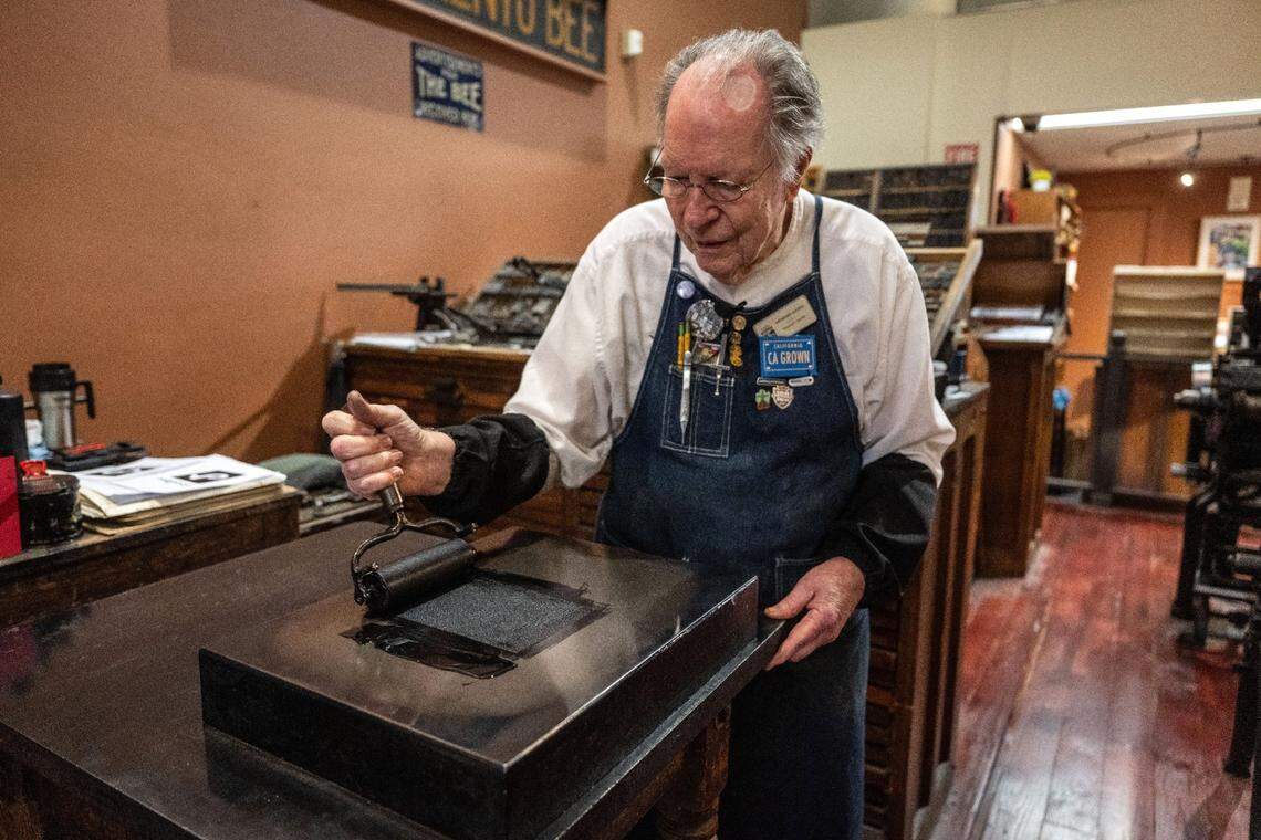 Volunteer docent Howard Hatch rolls ink in the print shop at the Sacramento History Museum in Old Sacramento on Friday. “Howard the Printer” became popular on TikTok during the COVID pandemic, but a federal law has put the future of the social media platform in doubt.