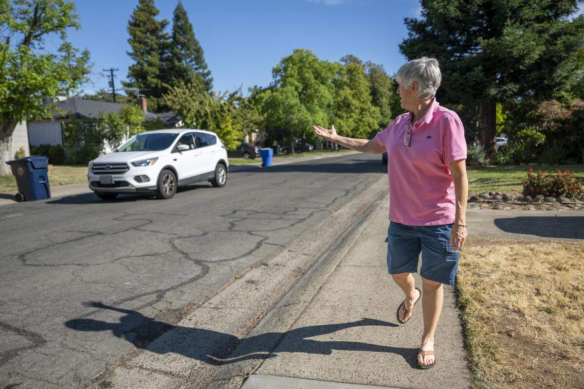 Nora Williams gestures as a car speeds by while speaking about the need for speed bumps on 62nd Street in Tahoe Park in July. 