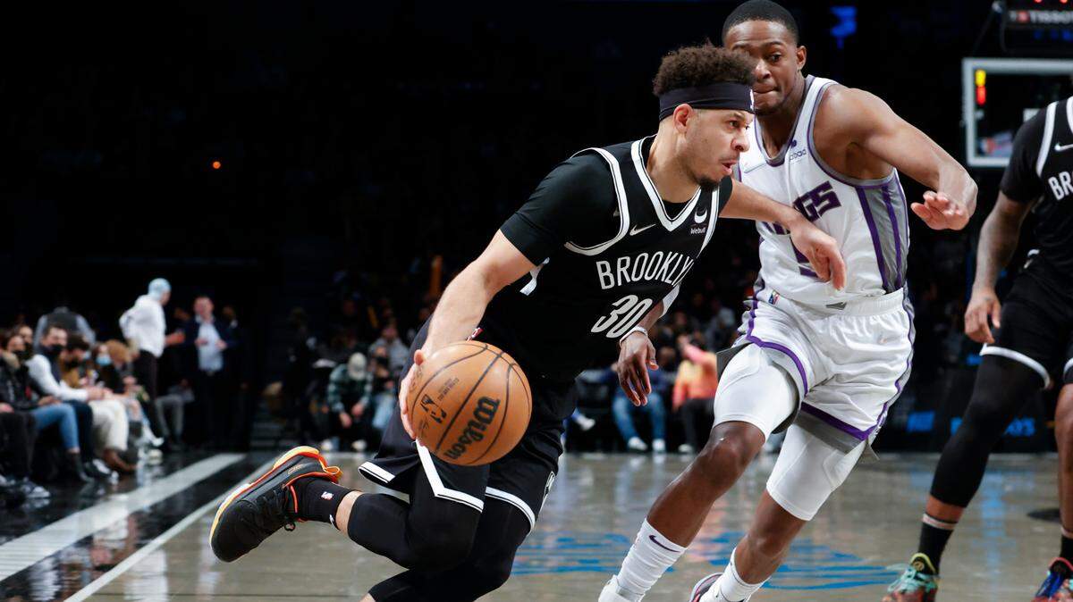Brooklyn Nets guard Seth Curry (30) drives past Sacramento Kings guard De’Aaron Fox (5) during the second half of an NBA basketball game Monday, Feb. 14, 2022, in New York. (AP Photo/Corey Sipkin)