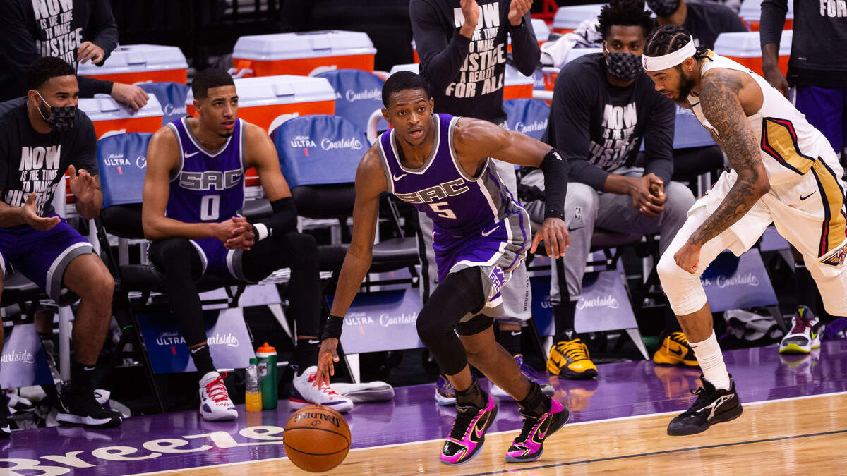 Sacramento Kings guard De’Aaron Fox (5) dribbles the ball away from New Orleans Pelicans forward Brandon Ingram (14) after forcing a turnover during the fourth period of the NBA game Sunday, Jan. 17, 2021, at Golden 1 Center in Sacramento. The Kings lost to the Pelicans 128-123.