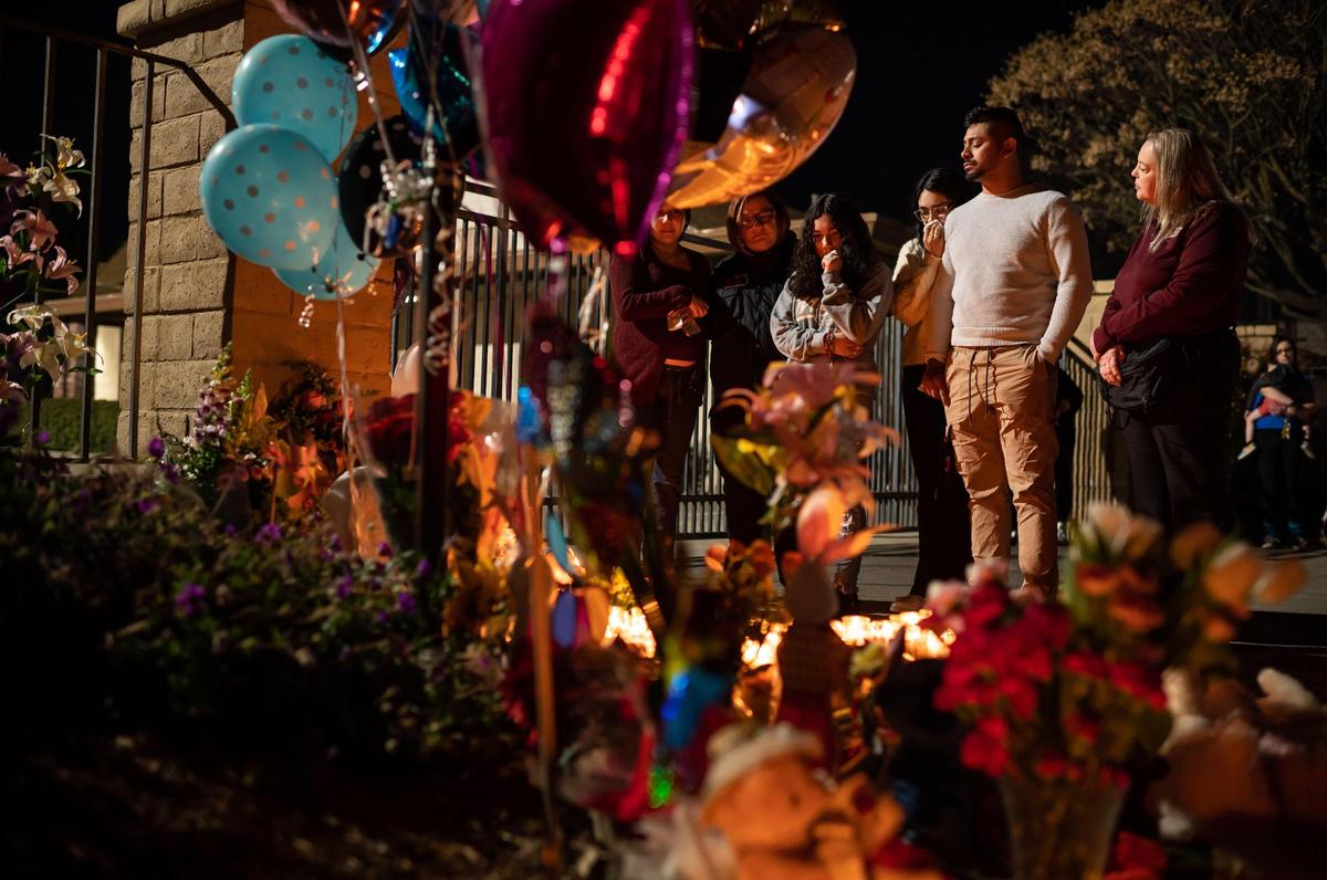 Mourners and law enforcement chaplains stand near a makeshift memorial for Samantha Mora Gutierrez, 10, Samarah Mora Gutierrez, 9, and Samia Mora Gutierrez,13, during a vigil Tuesday, March 1, 2022, outside Arden Arcade’s The Church in Sacramento. Community members held the vigil a day after the girls’ 39-year-old father shot and killed them along with chaperone Nathaniel Kong, then turned the gun on himself, inside the church on Wyda Way, authorities said.