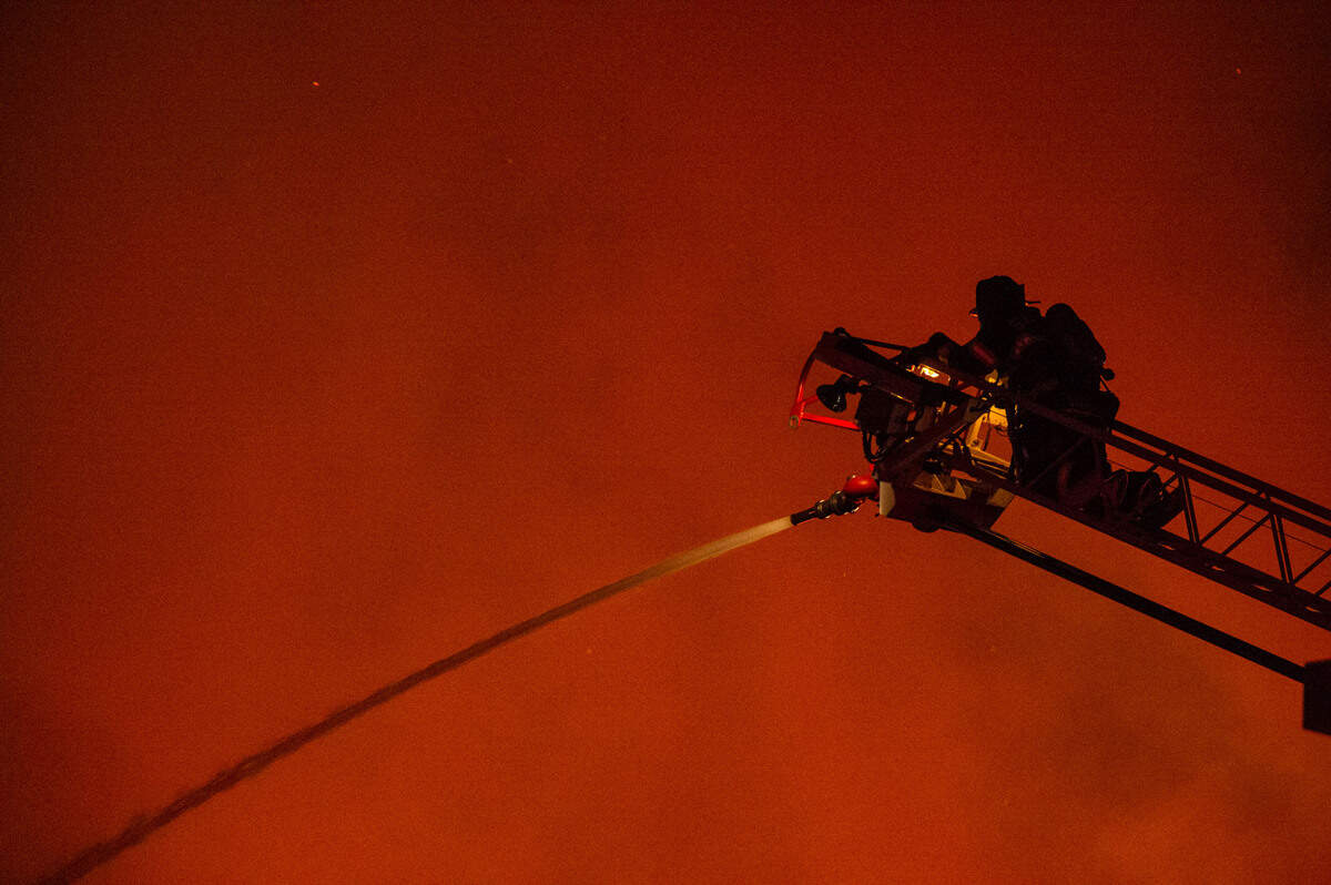 Firefighters battle a large pallet fire in an industrial section of Sacramento on Tuesday night, May 31, 2022.