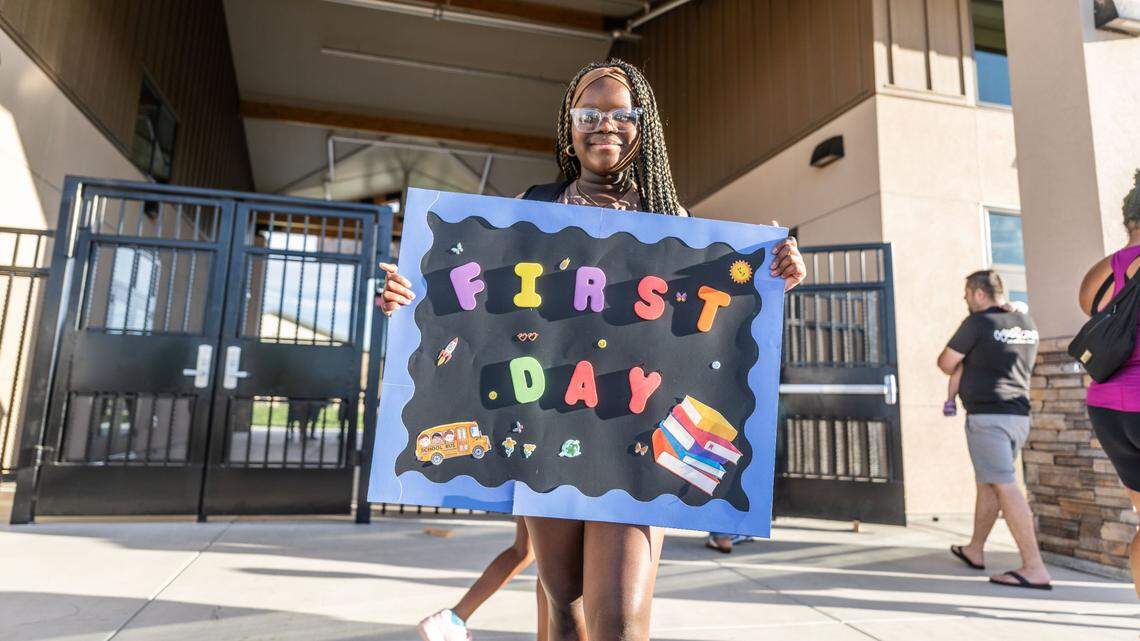 Seventh-grade student Ewa Akinsaya holds a first day of school sign at newly constructed Northlake TK-8 in North Natomas on Tuesday, Aug. 20, 2024. A Sacramento city council member fears crowded schools in the district because of a  proposed 25,000-person community that has yet to commit hundreds of millions of needed dollars to help build four new schools. 

