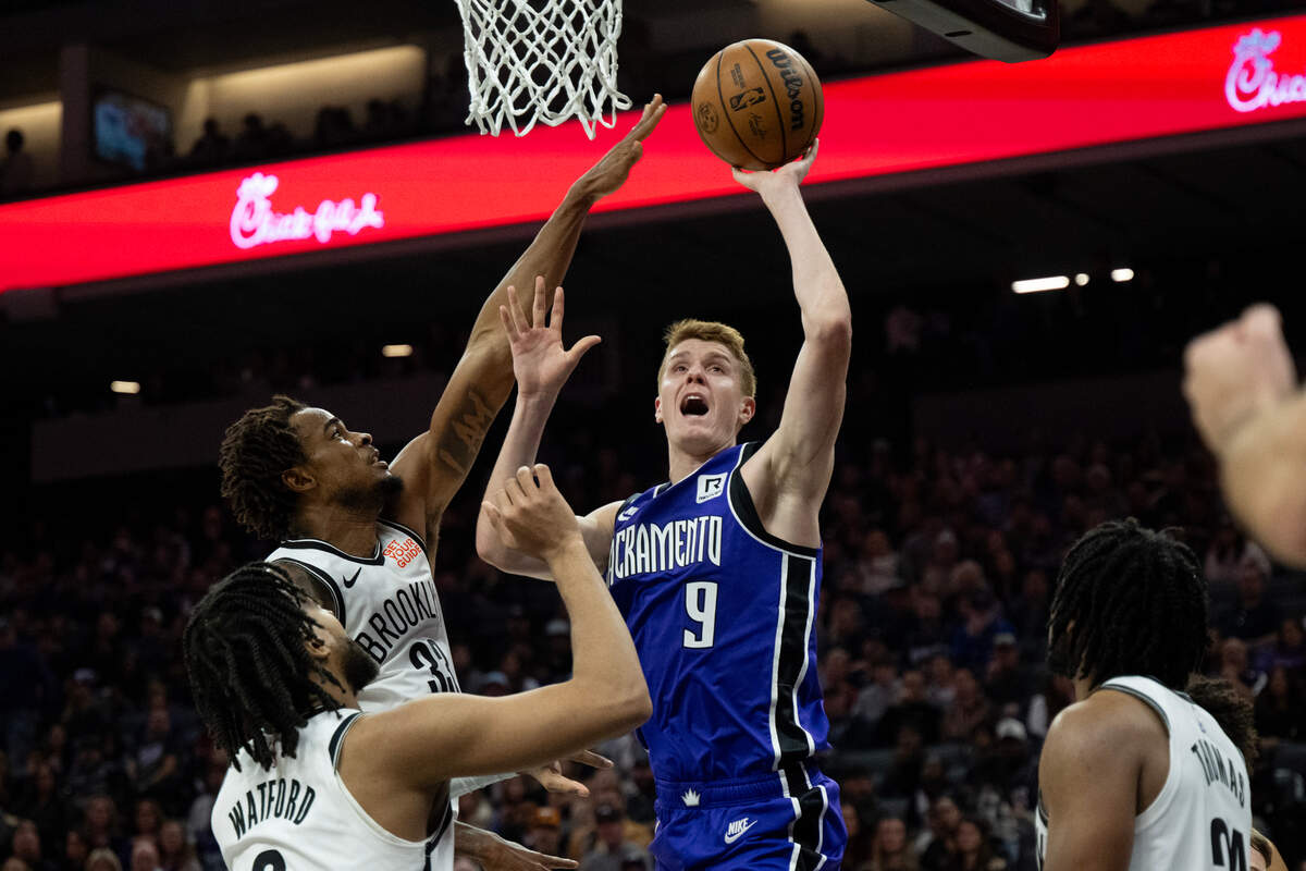 Sacramento Kings guard Kevin Huerter (9) drives to the basket and is fouled by Brooklyn Nets center Nic Claxton (33) during an NBA game at Golden 1 Center on Sunday, Nov. 24, 2024.