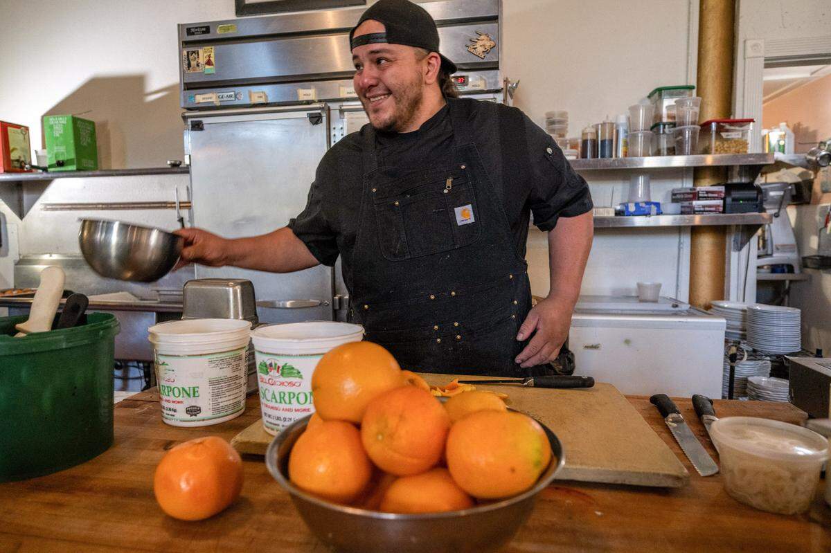 Tone Alcantara, a recent graduate from the Reintegration Academy, works at Mulvaney’s B&L in Sacramento on May 27. He said that although he learned how to prepare a résumé and originally hoped to work as a contractor while at the academy, he’s enjoying his part-time job so much that he hopes to stay at the restaurant full-time.