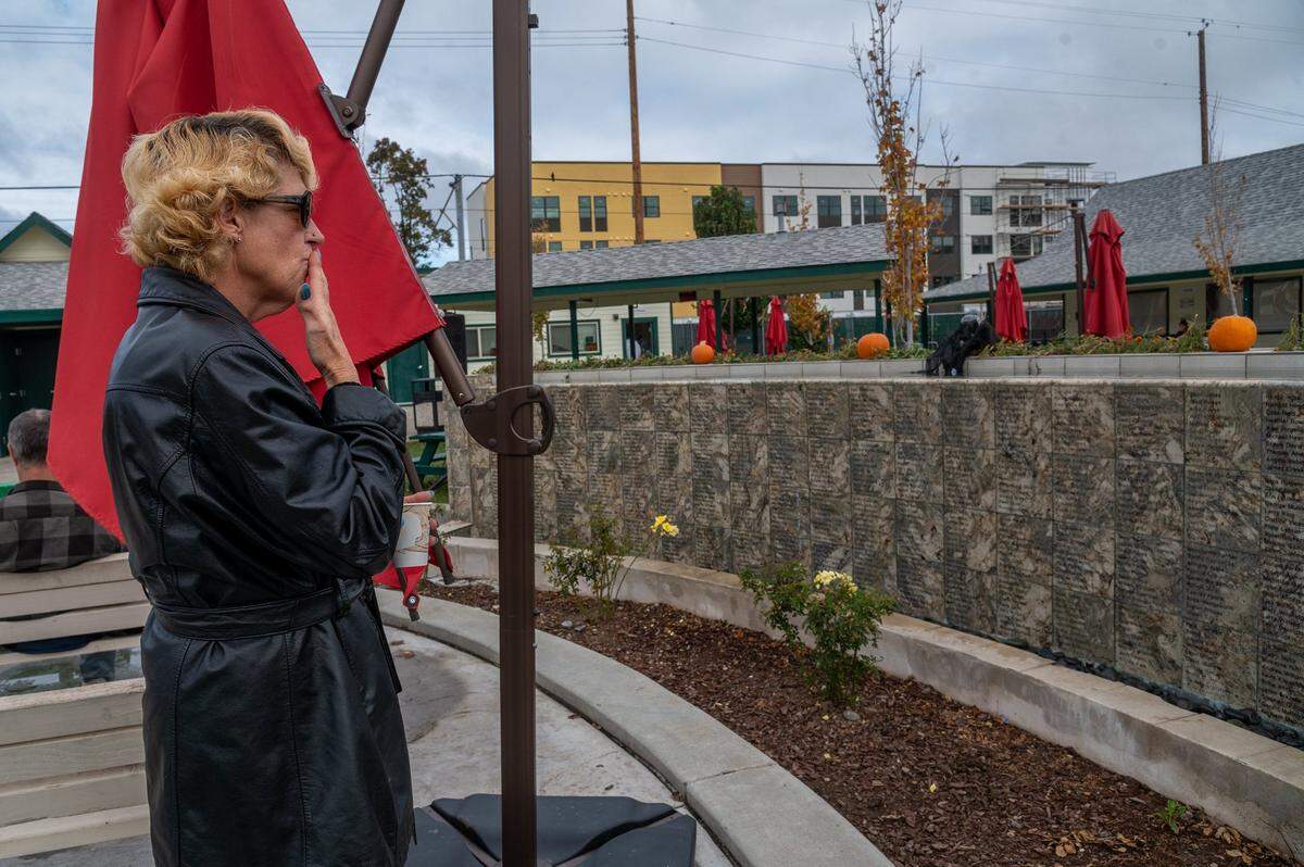 Latricia “Lovely” McCatherine throws a kiss toward a memorial wall for her late husband Jonnie “Rambo” McCatherine, one of over 800 homeless people who have died in Sacramento since 1990, at Loaves and Fishes in November. “During the day I come through here and always blow kisses … always blow kisses to him,” said McCatherine, who lives on the river in a tent where her husband died of pneumonia in February.