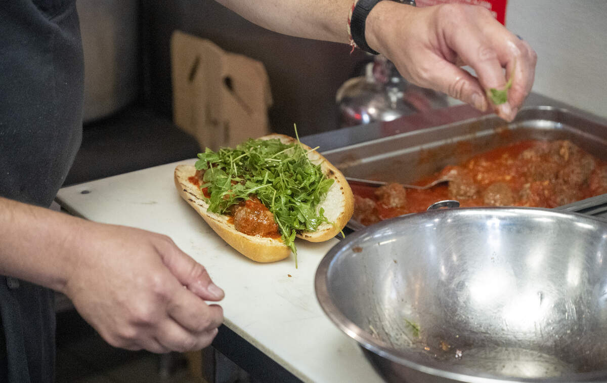 Joe Pruner, owner and chef of upcoming restaurant Bocce, prepares a sandwich before his restaurant’s pop-up event at Origami Asian Grill in Sacramento on Sunday, June 7, 2026.