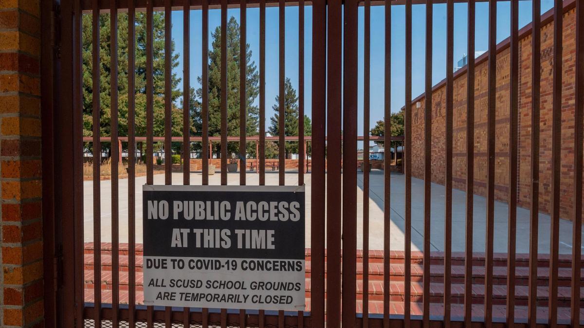 A sign at the entrance to the Hiram Johnson High School campus denies public access due to concerns over COVID-19, as students begin the fall semester with distance learning, Thursday, September 3, 2020, in the Sacramento City Unified School District.