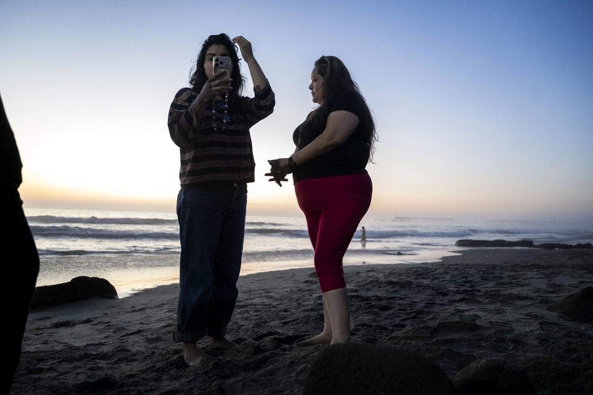 Maria de Jesus Estrada, a DACA recipient that was deported in February to Mexico, listens to a Zoom call with Ivonne Rodriguez on the beach in Rosarito, Mexico, on Sunday, March 29, 2026.