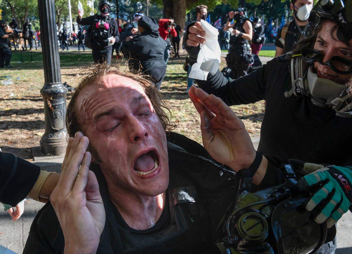 Loren Kidd screams out in pain after being pepper sprayed during a conflict with Trump supporters and “Proud Boys” at the Capitol in Sacramento on Saturday, Nov. 14, 2020. “They came right at me, pulled my mask off, and kept spraying before the police came to break it up,” said Kidd.
