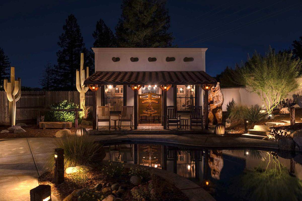 A stunning Old West saloon overlooking a pristine pool is part of a Gold Rush-themed backyard in Folsom.