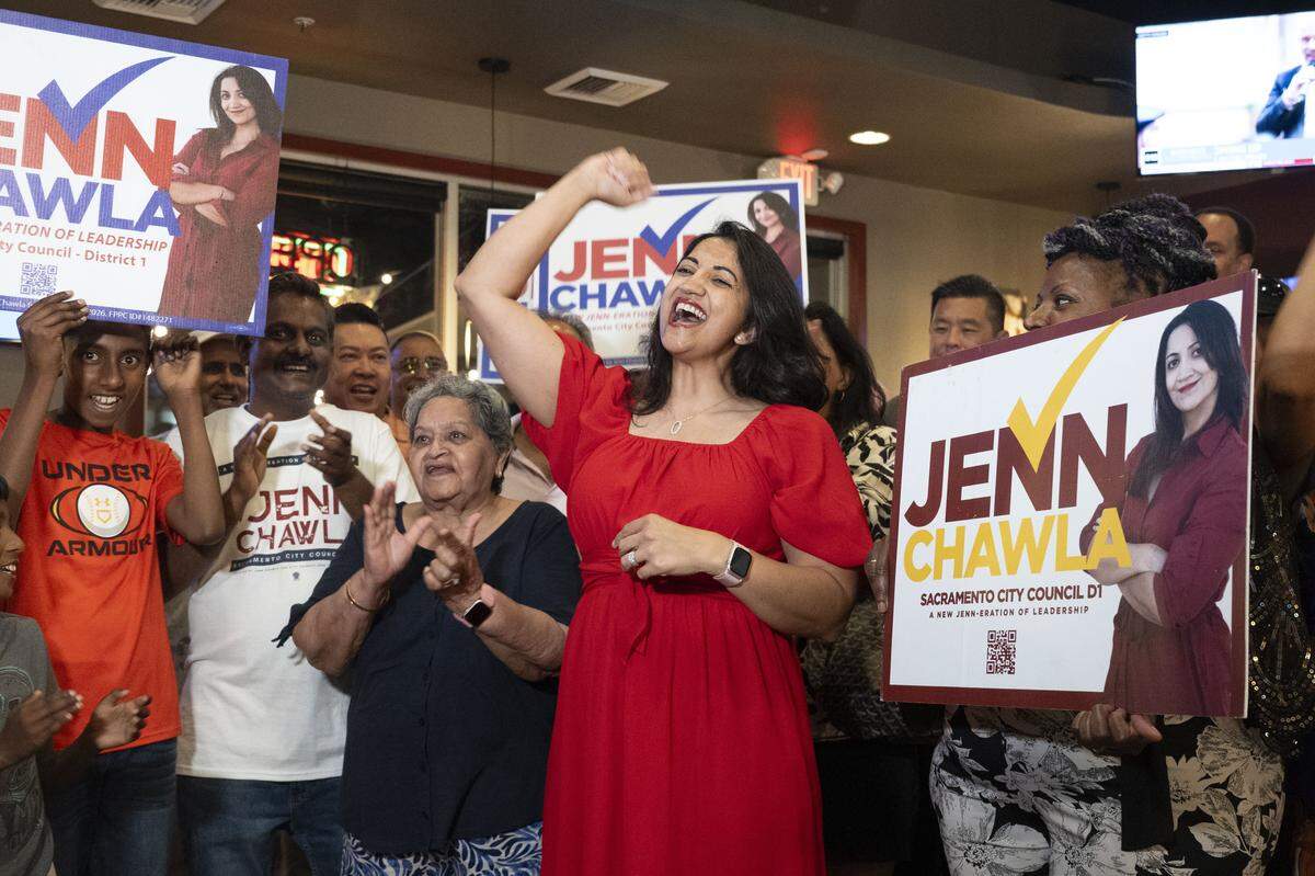 Sacramento City Council candidate Jenn Chawla cheers with her supporters during a TV interview at her election night party at Frends Brewhouse in South Natomas on Tuesday.