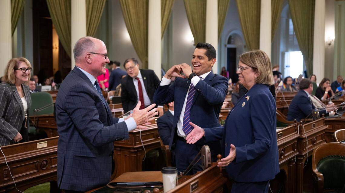 Assemblyman Gregg Hart, D-Santa Barbara, a co-author of AB x2-1, is congratulated by Miguel Santiago, D-Los Angeles, center, and co-author Cecilia Aguiar-Curry, D-Winters, after the bill passed during a special session on Tuesday. The bill, intended to prevent gasoline price spikes, must be approved by the state Senate before it can be signed by the governor.