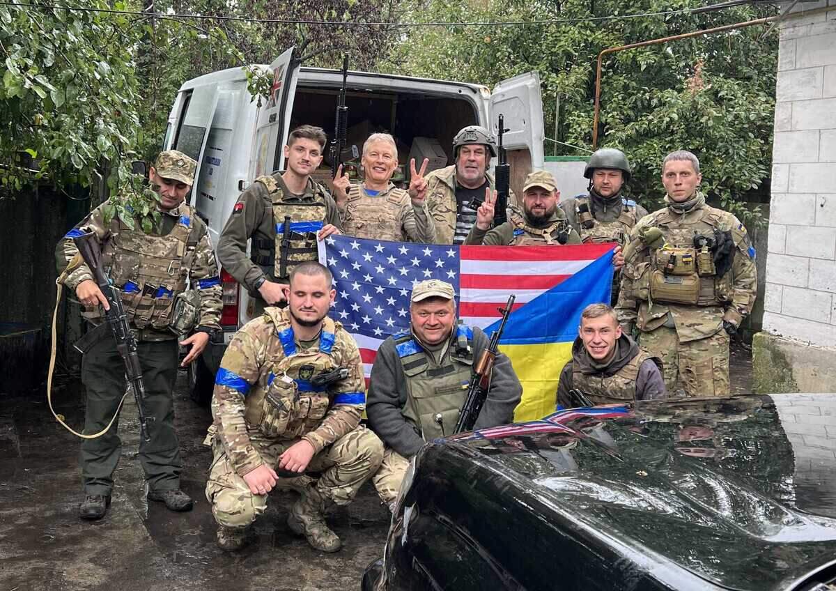 Art Ballard, background center, poses with Ukrainian soldiers during a trip to the war-torn nation in 2022. On Friday, the Sacramento resident will fly back to Poland so that he can take part in volunteer relief efforts over the border. It will be his third trip to the region since fighting began.