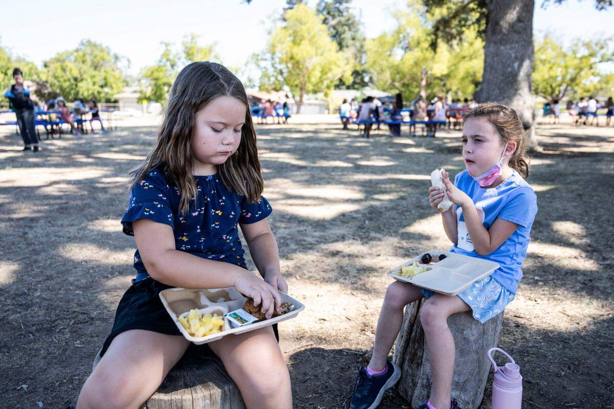 Sera Falling and Harper Carrasco, second grade students at Alice Birney Waldorf-Inspired K-8 School, eat their lunch earlier this month. The school receives its food from the Sacramento City Unified School District’s Central Kitchen. After years of slow progress, millions of dollars are flowing toward locally-sourced school lunches, helping offset some of the costs associated with higher-quality food.